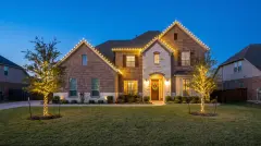 Professional Christmas light installation on a two-story brick home in Round Rock, TX