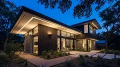 Permanent LED Christmas lights hidden under the eaves of a home in Austin, Texas