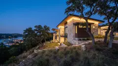 Permanent LED Christmas lights hidden under the eaves of a Lake Travis hillside estate in Lakeway, TX