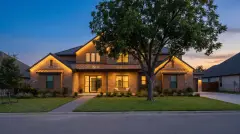Permanent LED Christmas lights hidden under the eaves of a two-story suburban home in Pflugerville, TX